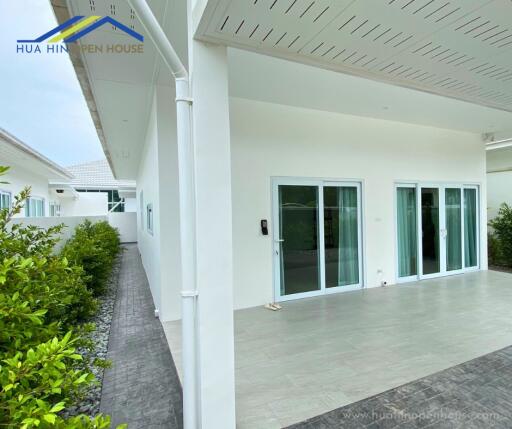 Exterior view of the house featuring sliding glass doors