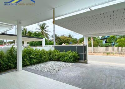 Modern covered driveway with garden