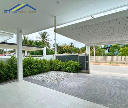 Modern covered driveway with garden