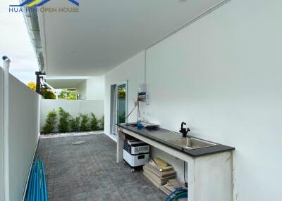 Outdoor area with sink and storage