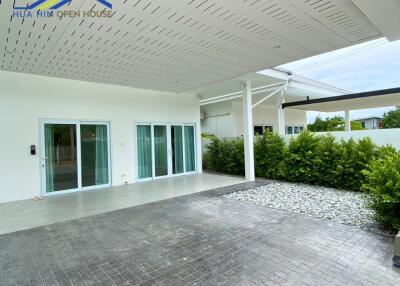 Covered patio and garden area with sliding glass doors