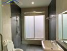 Modern bathroom with shower, toilet, and sink