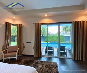 Bedroom with view of a pool