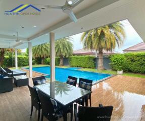 Spacious outdoor patio with pool and seating area