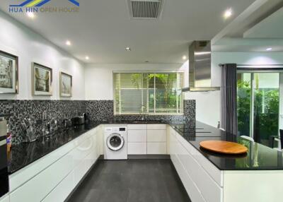 Modern kitchen with black countertops and white cabinets