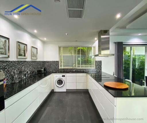 Modern kitchen with black countertops and white cabinets