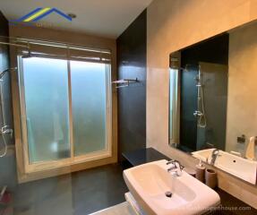 Modern bathroom with glass-enclosed shower and sink