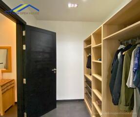 Walk-in closet with organized shelving and hanging space