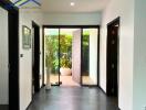 Main entrance with a glass door and indoor plants