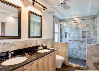 Modern bathroom with dual sinks and a glass shower enclosure