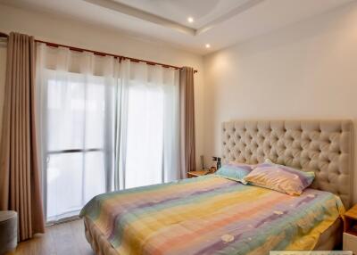 Bedroom with a large bed, ceiling fan, and natural light