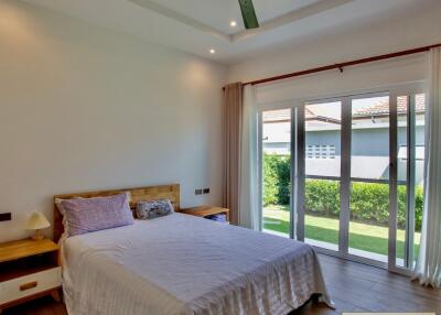 bedroom with a large window and garden view