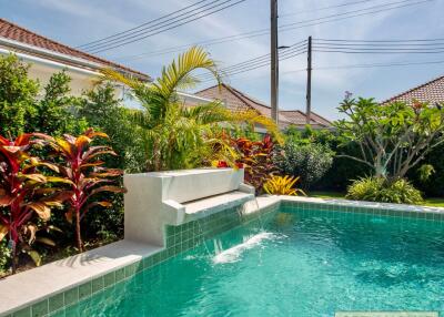 Beautiful backyard with swimming pool and lush greenery