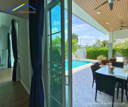 Living area with view of patio and swimming pool