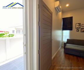 Interior view of living room with sofa and wooden flooring