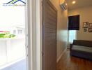 Interior view of living room with sofa and wooden flooring