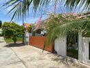 Beautiful exterior view of a house with a garden and wooden gate