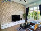 Modern living room with feature wall, large TV, and comfortable seating