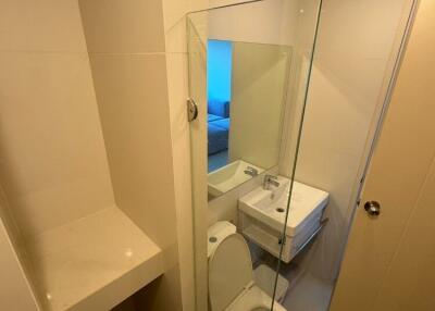 Modern bathroom with glass shower and white fixtures