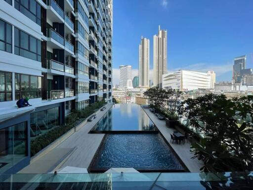 High-rise building with outdoor swimming pool and city view