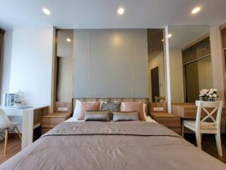 Modern bedroom with bed, nightstands, and vanity