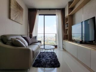 Modern living room with large window and city view