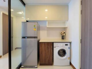 Modern kitchen with fridge and washing machine