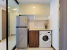 Modern kitchen with fridge and washing machine