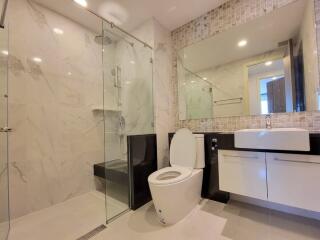 Modern bathroom with glass shower and large mirror