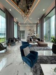 Modern living room with floor-to-ceiling windows, stylish furniture, and contemporary decor.