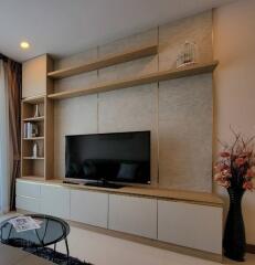 Modern living room with wall-mounted TV and built-in shelving