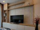 Modern living room with wall-mounted TV and built-in shelving