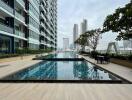 Outdoor swimming pool area with cityscape view