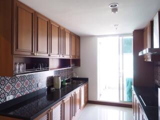 Spacious kitchen with wooden cabinets and modern appliances