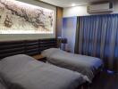 Modern bedroom with twin beds and wall-mounted air conditioner