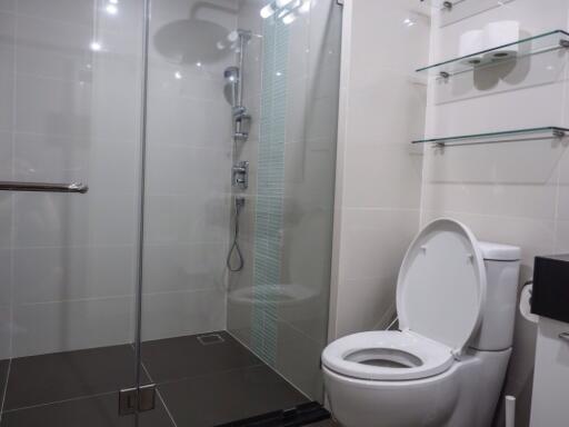 Modern bathroom with glass shower enclosure and toilet