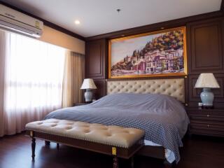 Luxury bedroom with a large bed, artwork, and furniture