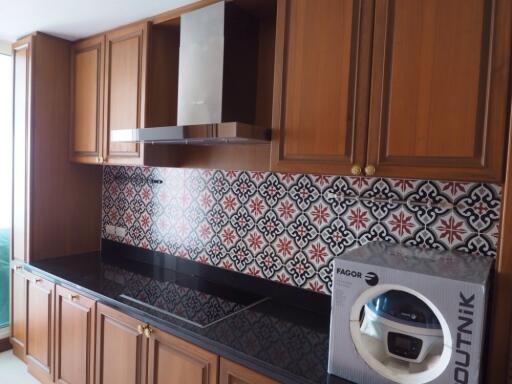 Modern kitchen with wooden cabinets and patterned backsplash