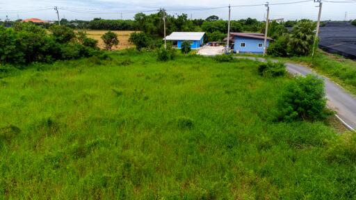 Aerial view of a rural land with two small buildings and greenery