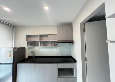 Modern kitchen with grey cabinets and black countertop