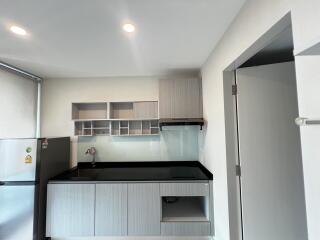 Modern kitchen with grey cabinets and black countertop