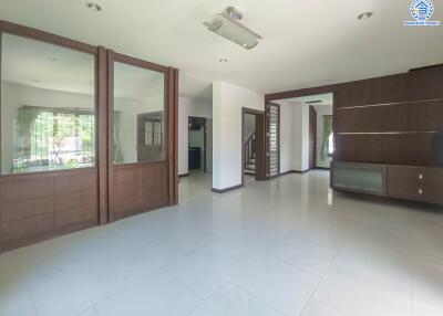 Spacious living room with large windows and modern lighting