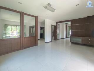 Spacious living room with large windows and modern lighting