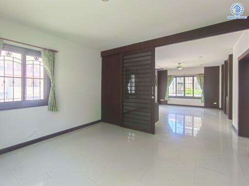 Spacious main living area with large windows and tiled floor