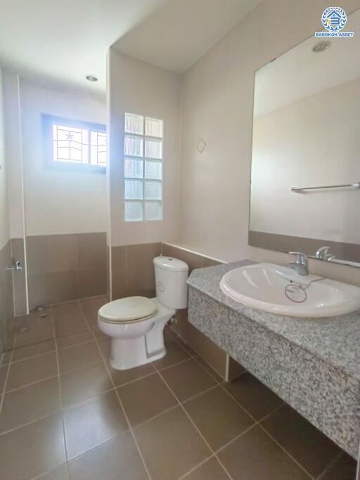 Modern bathroom with sink, toilet, and walk-in shower