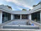 Exterior view of a modern house with a courtyard pool