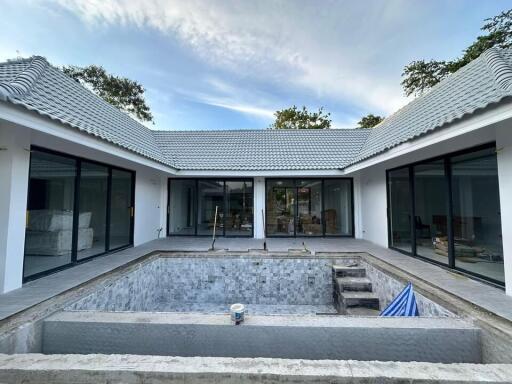 Exterior view of a modern house with a courtyard pool