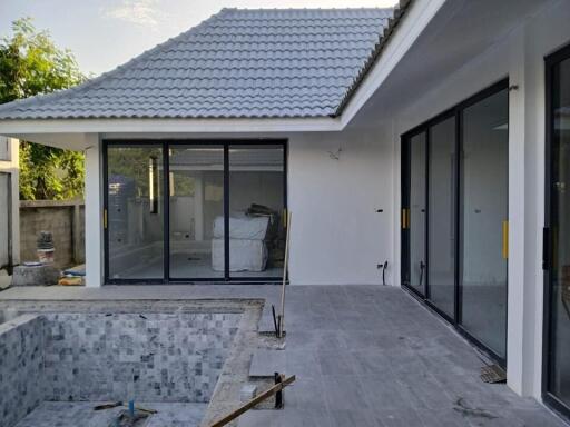 Exterior view of the property showing a pool area under construction