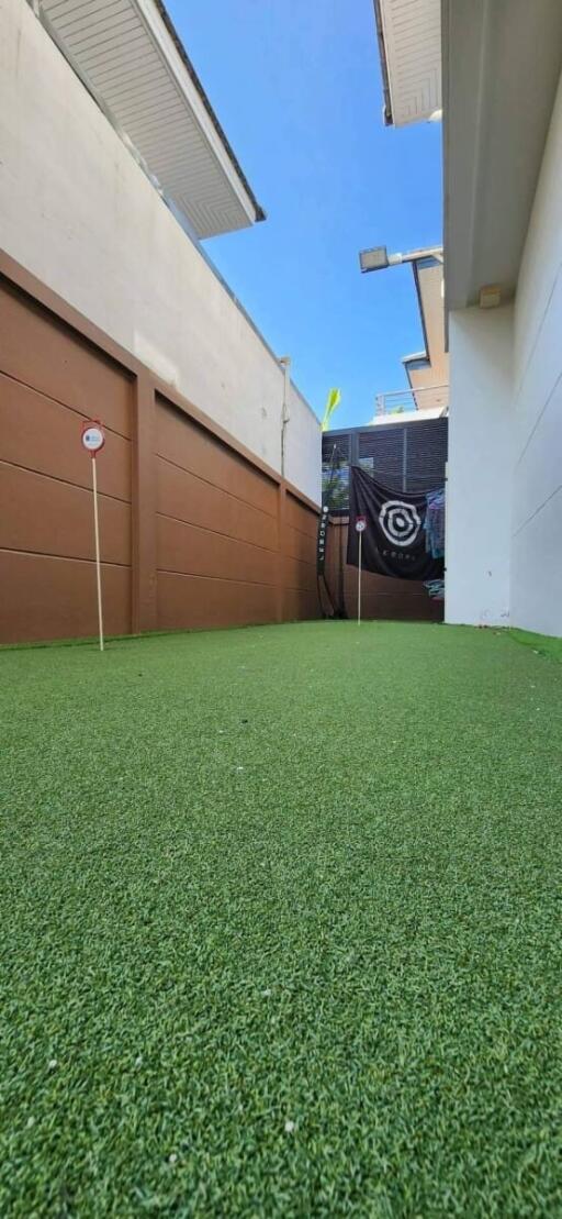 Outdoor area with artificial turf suitable for recreation