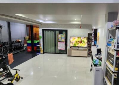 Modern living room with gym equipment and a TV